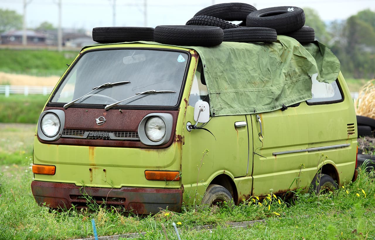 White Daihatsu Hijet kei truck front three-quarter view
