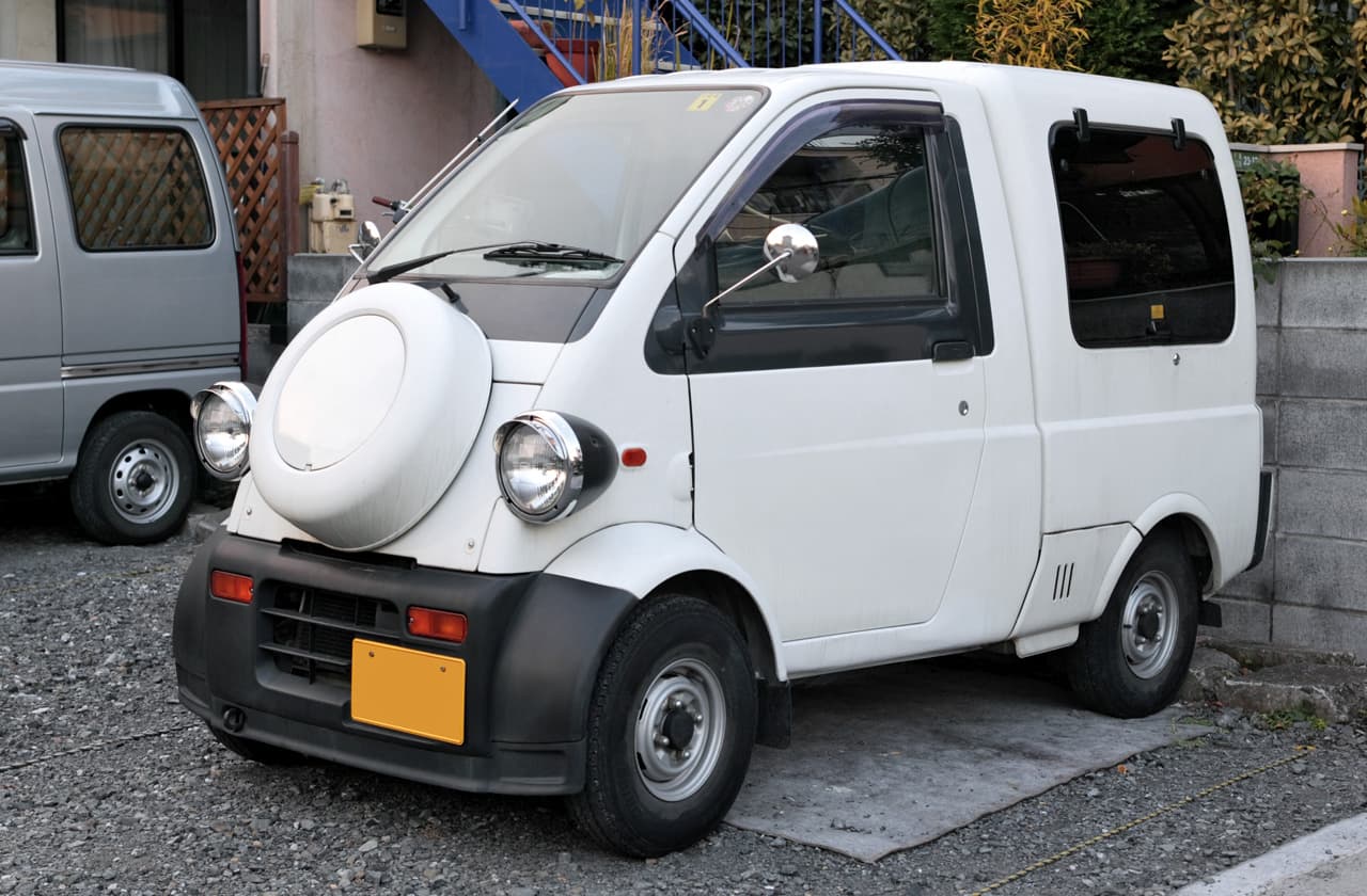 White Daihatsu Midget II Cargo single-seat kei truck front three-quarter view