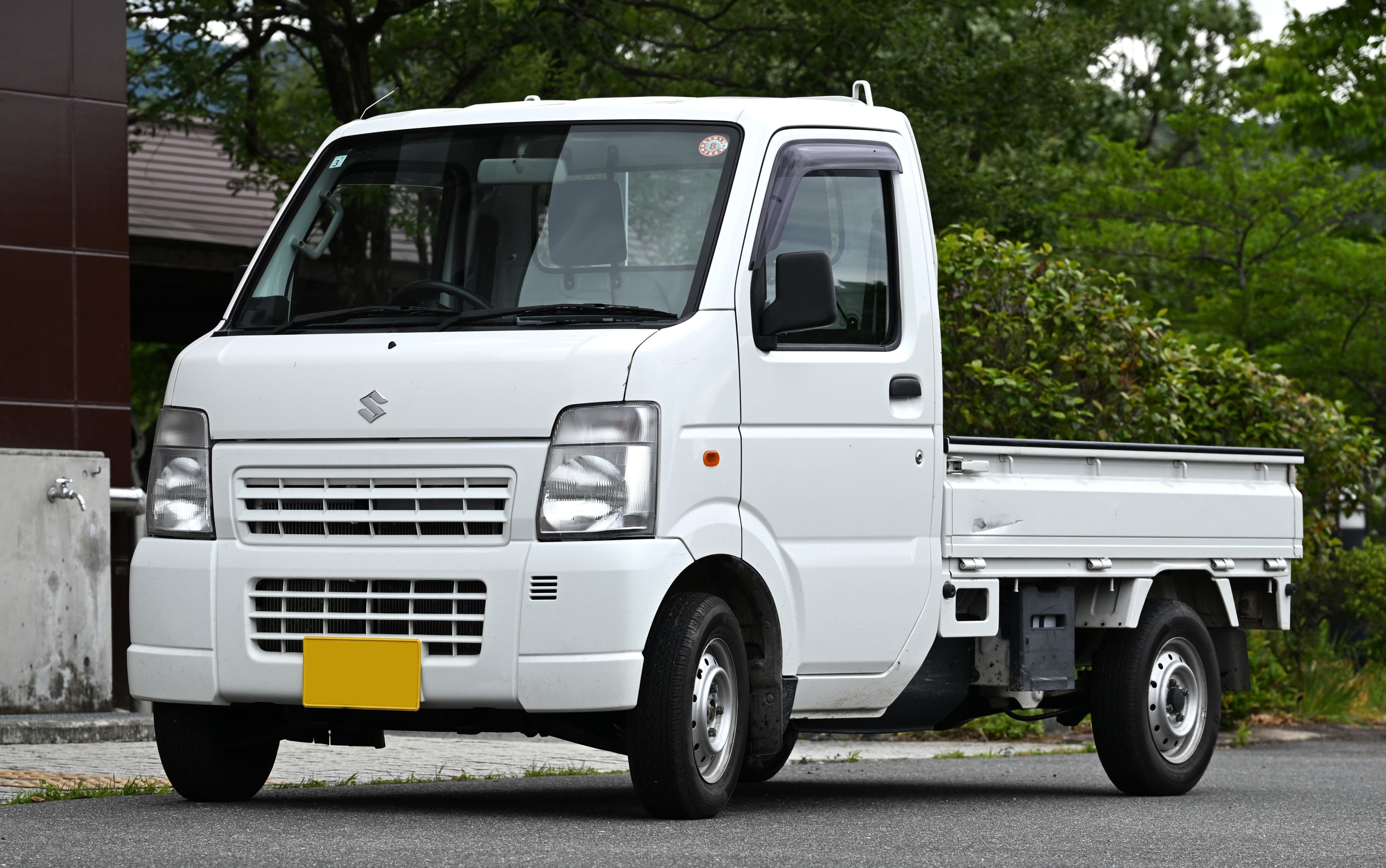 Honda Acty with bright white LED headlights at dusk